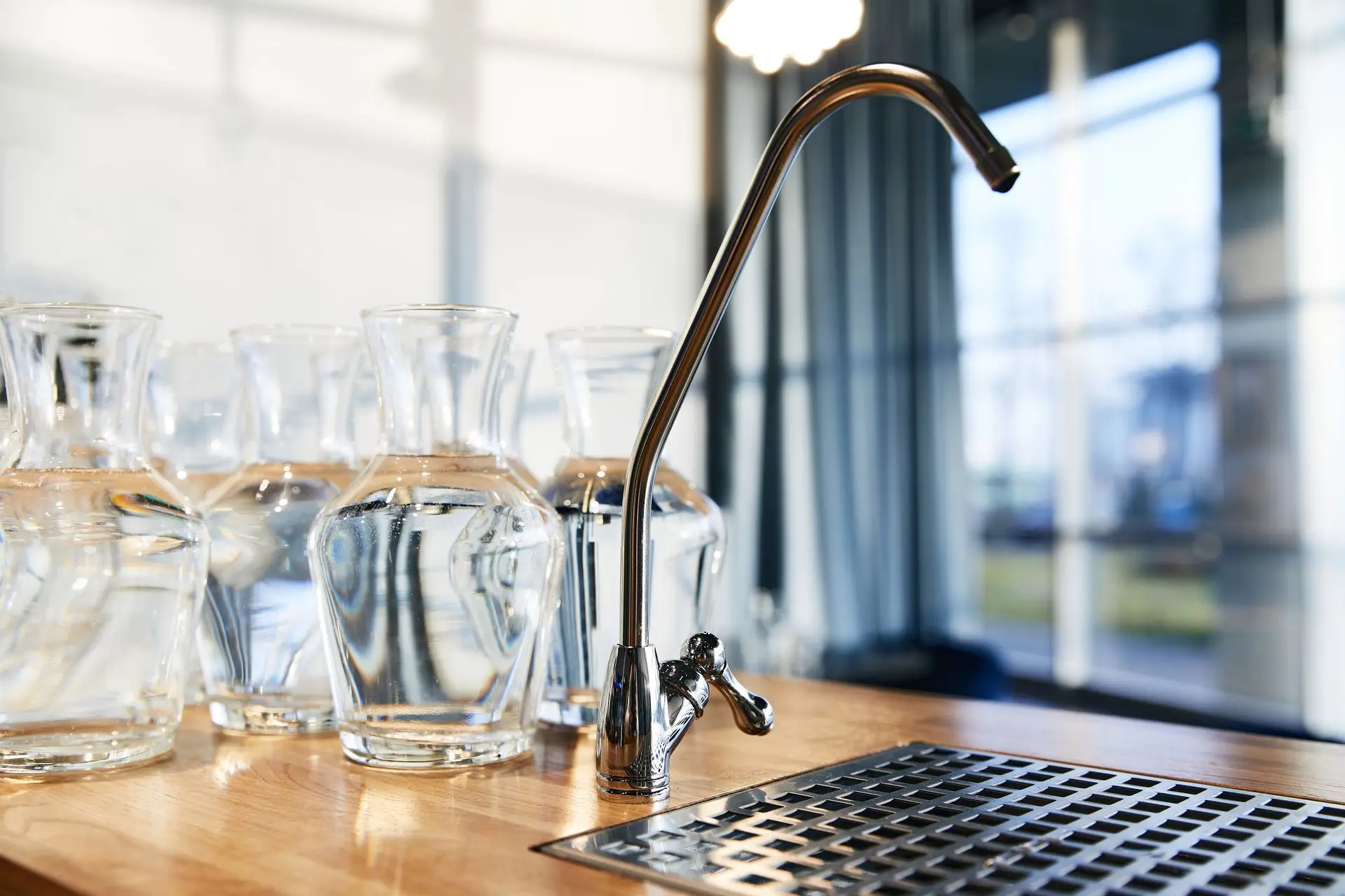 Filter tap above a counter of glass carafes