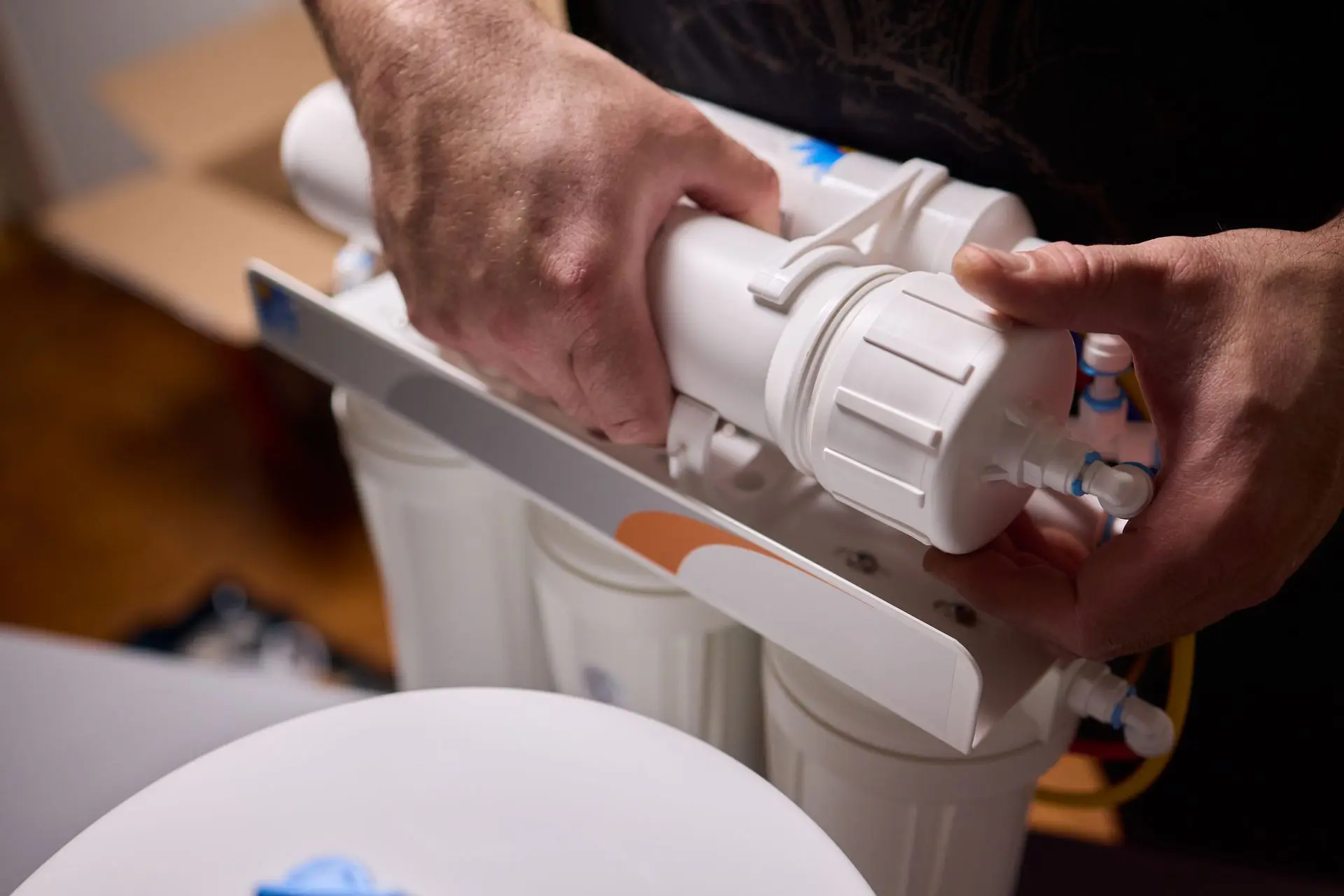 Technician installing a reverse osmosis unit