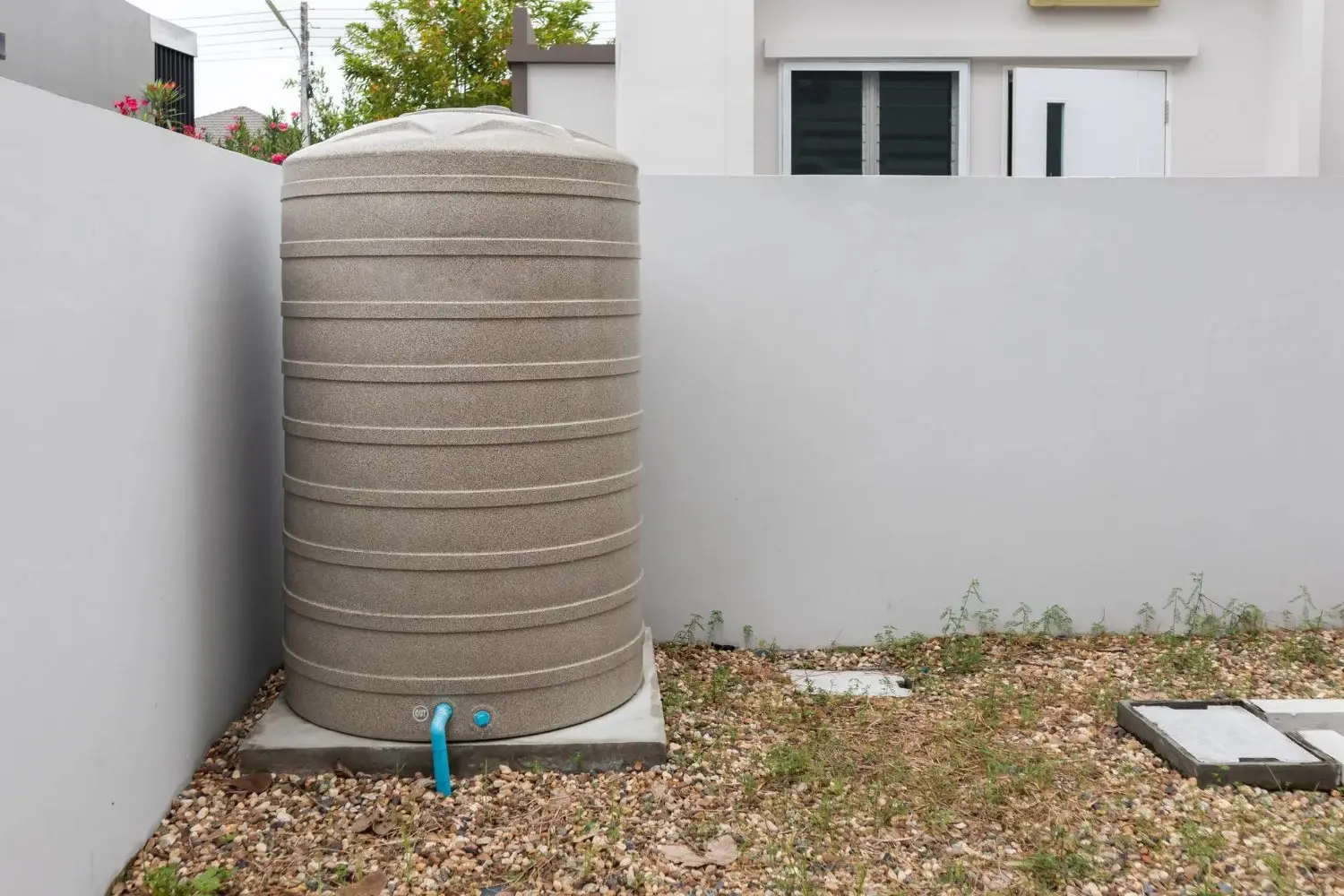 Water storage tank on a concrete base in a walled garden